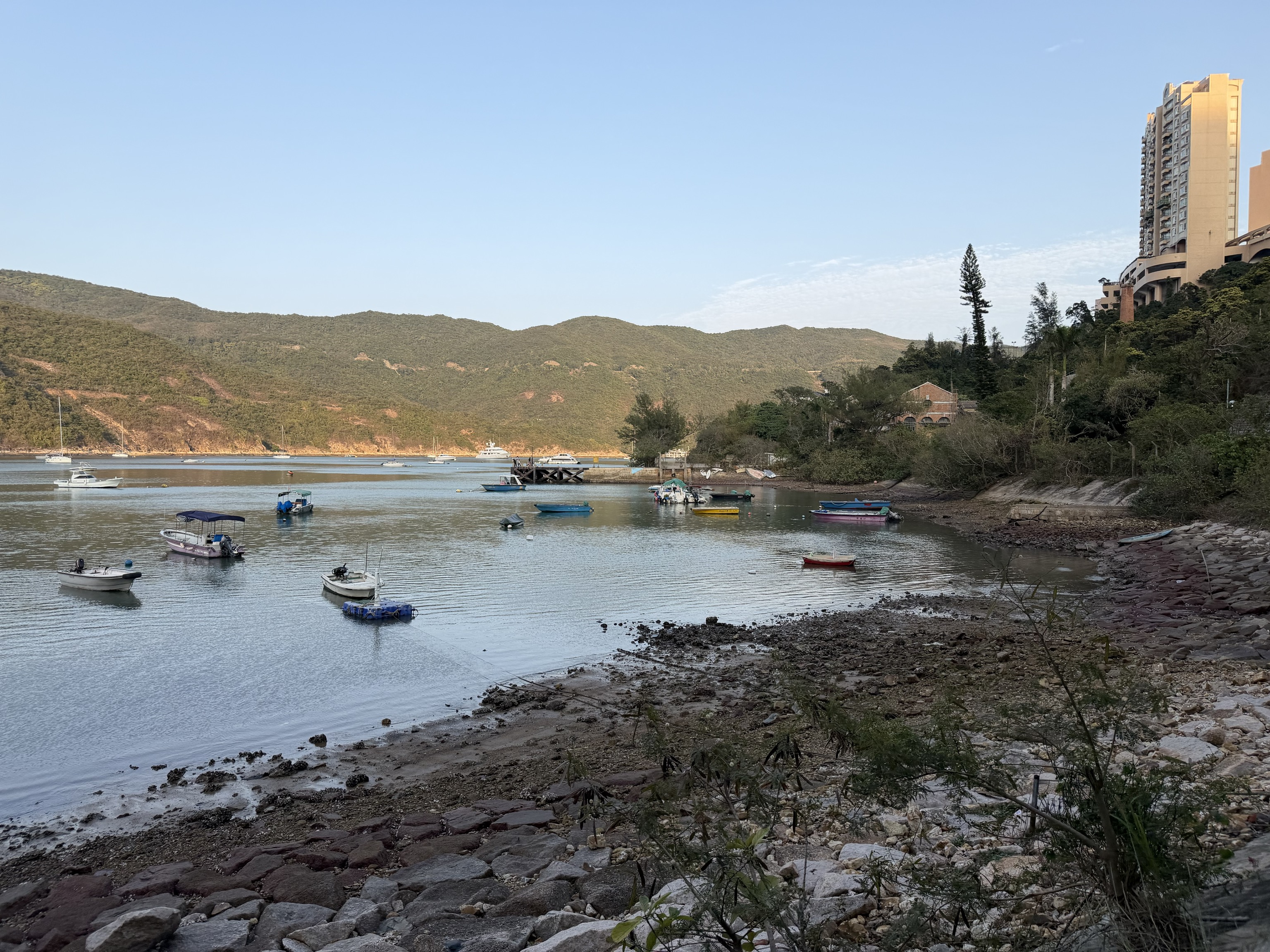 A small bay with several anchored boats in it. A small bay with several anchored boats in it.