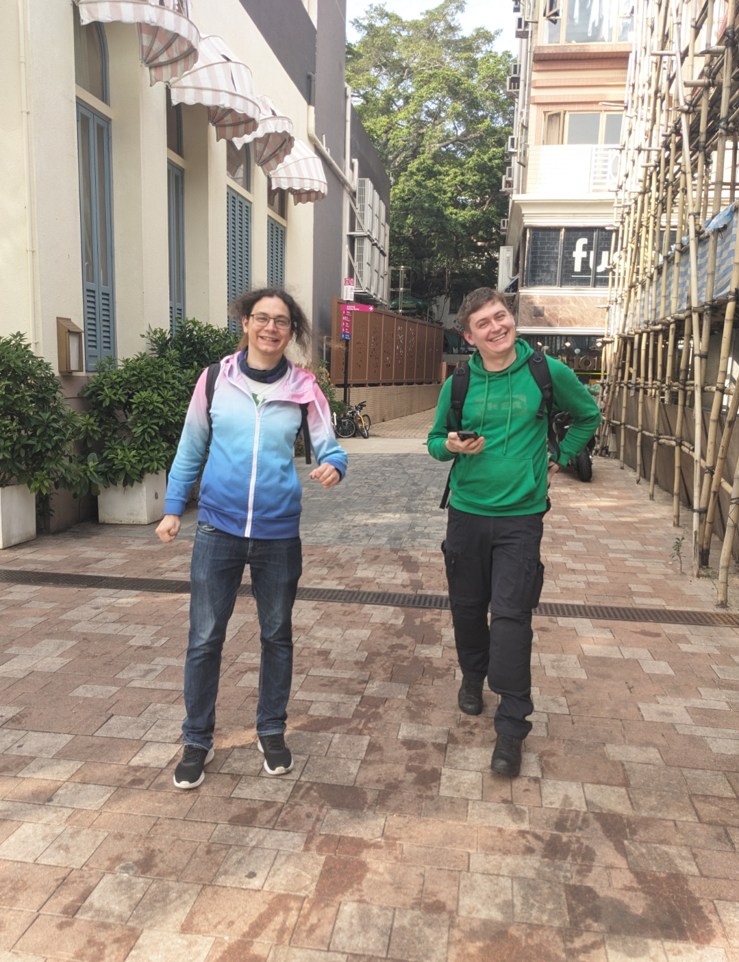 Two white people im colorful clothes grin cheerily into the camera. Two white people im colorful clothes grin cheerily into the camera.