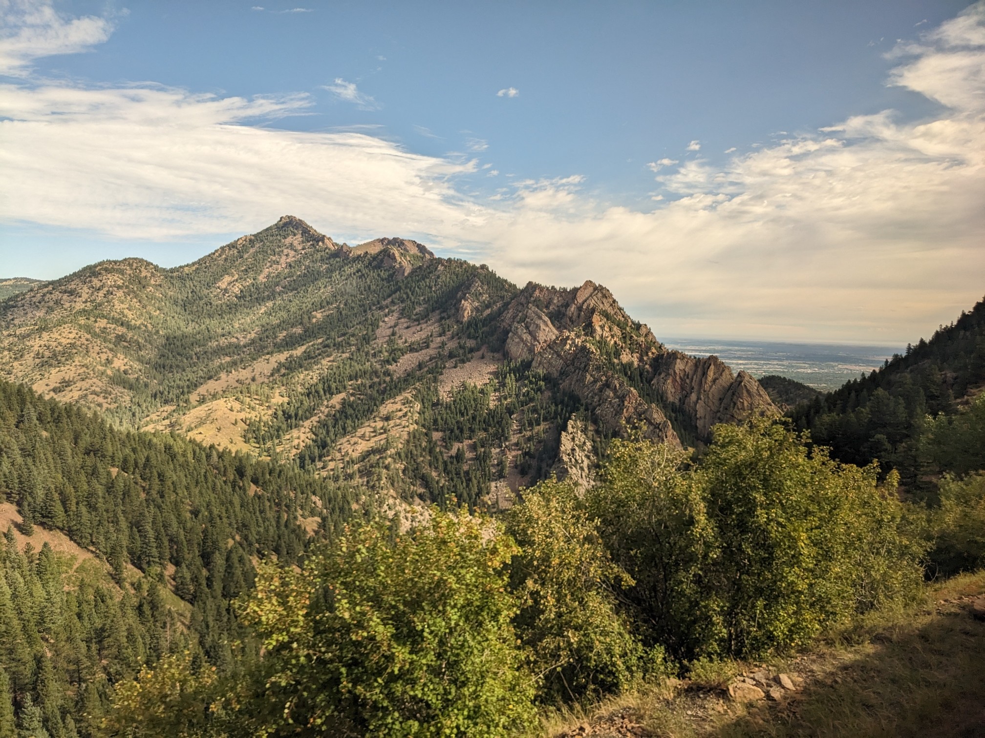 Both pics show forest-covered mountains.