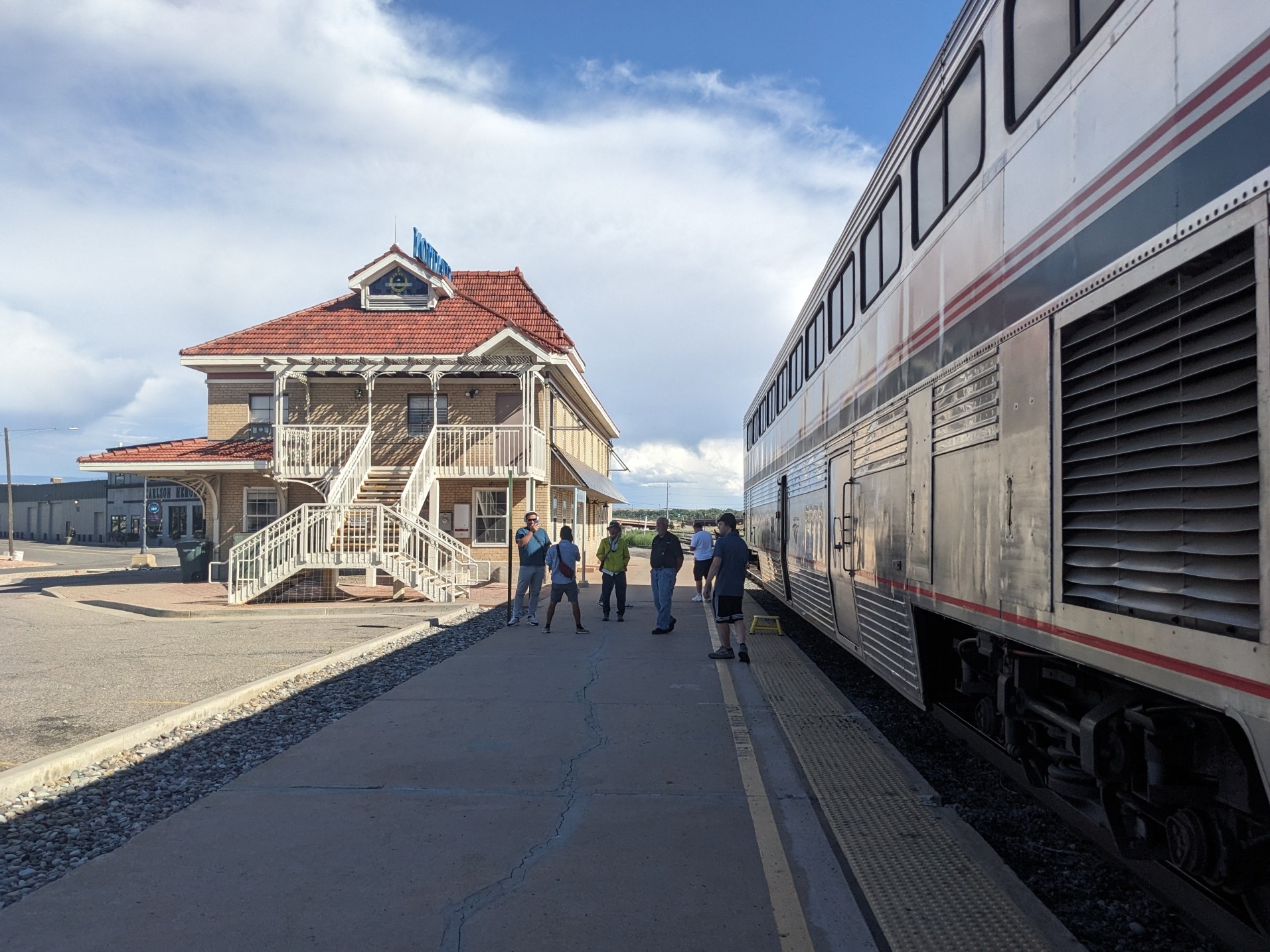 Our train is stopped in front of a big wooden house at the platform.