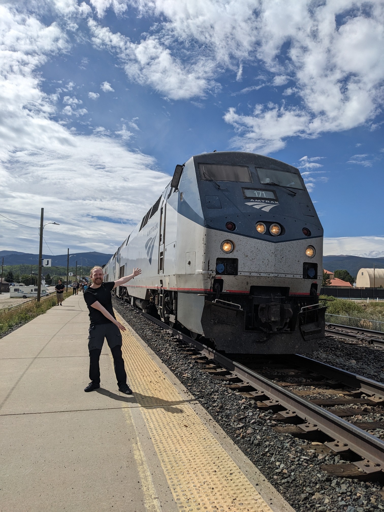 I'm pointing at a big Amtrak train. Mountains in the distance.