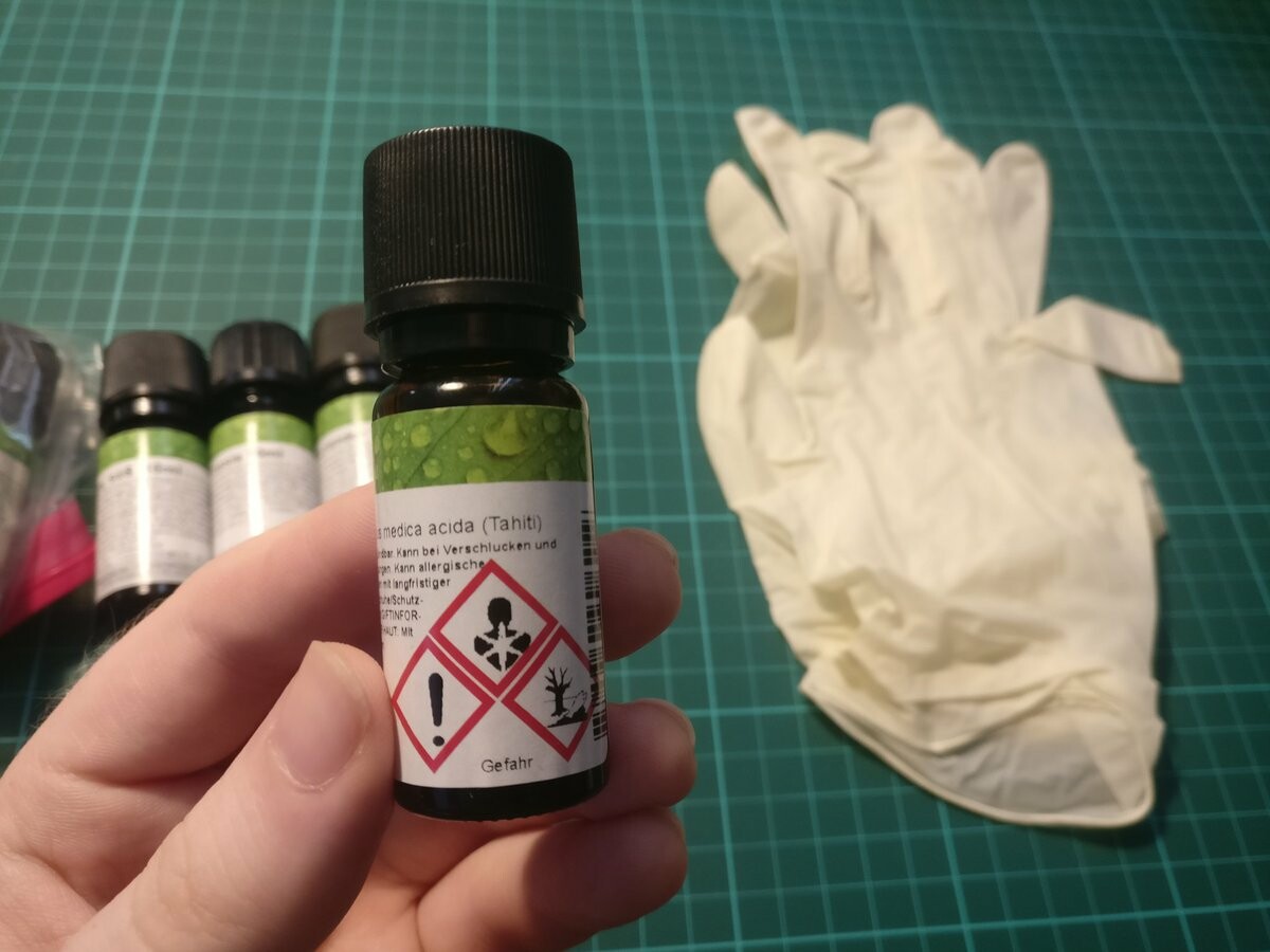 I'm holding a bottle of an essential oil. It has safety warnings printed on it.