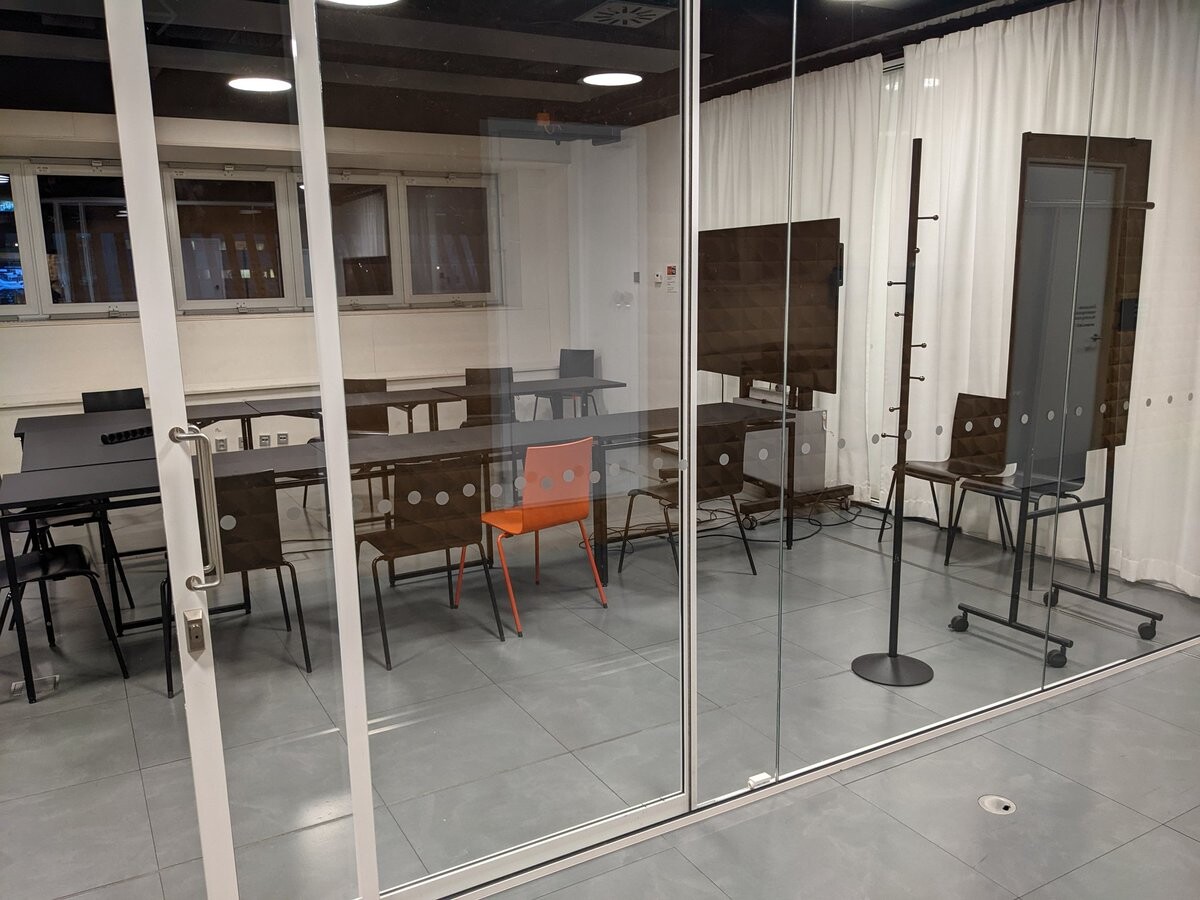 A meeting room behind a glass wall.