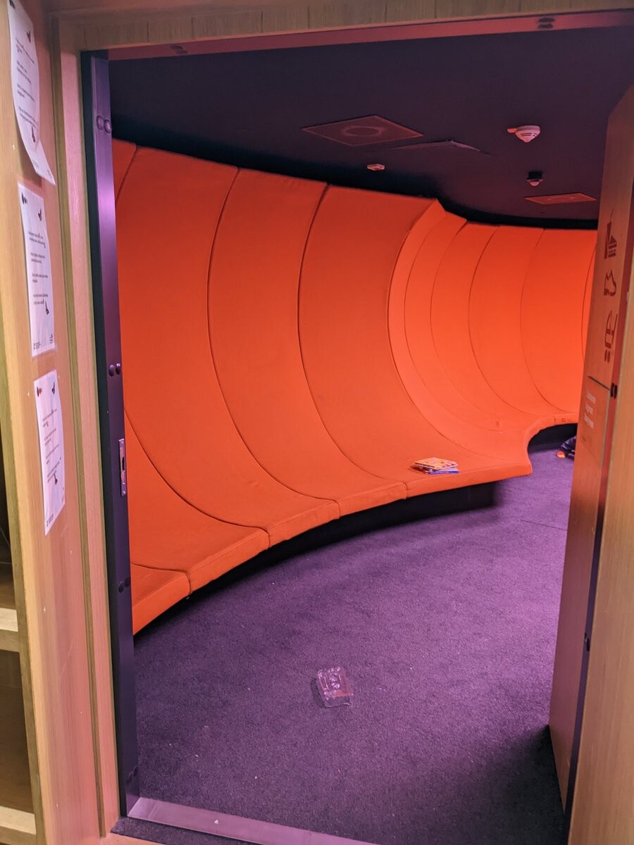 A fluffy room with strangely shaped sitting space.