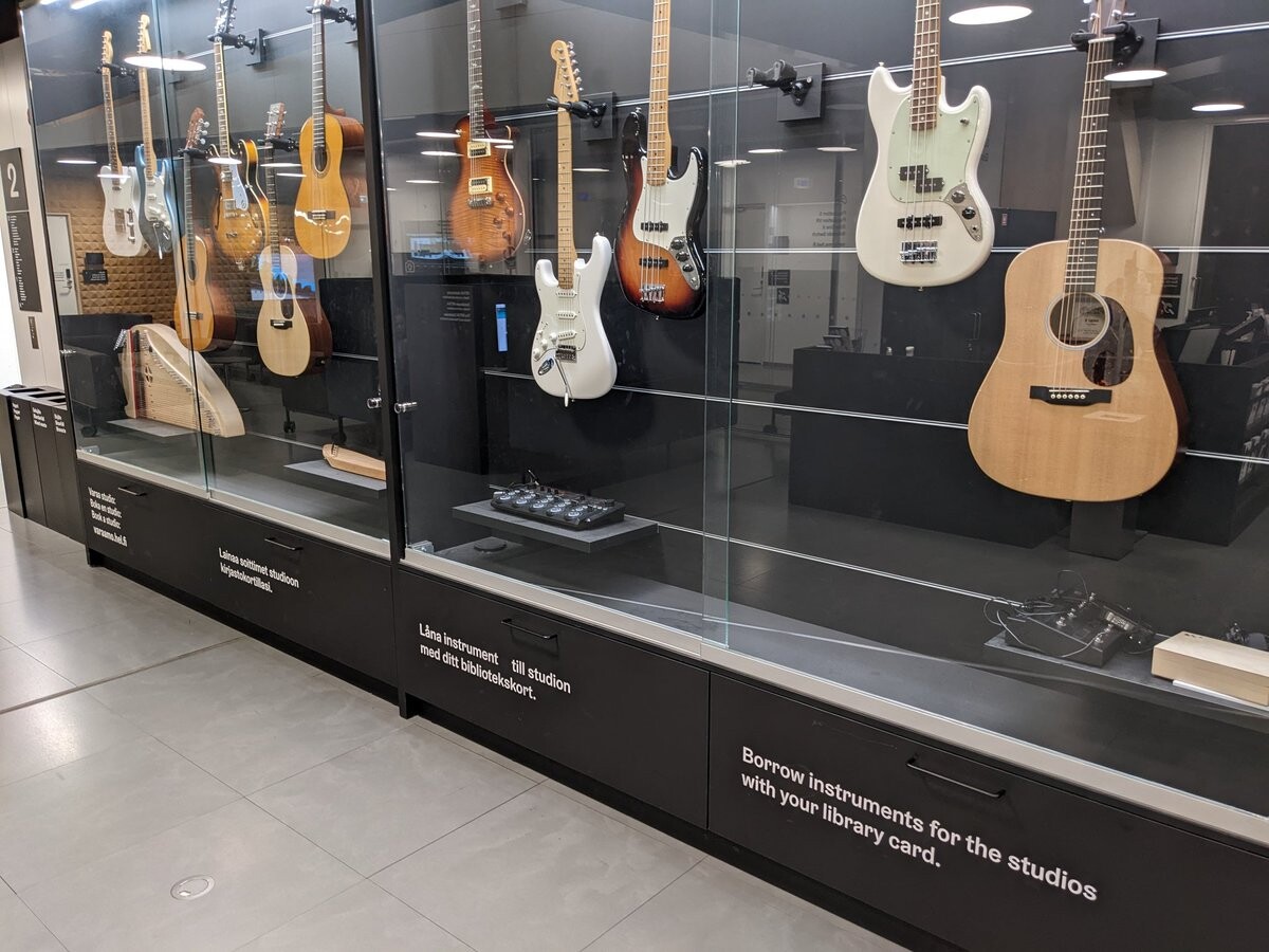 Guitars in a glass showcase.