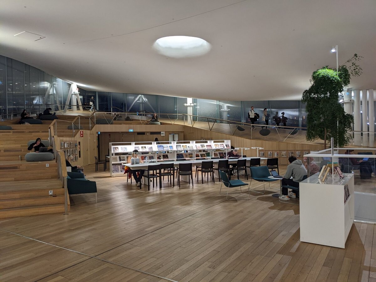 Another wooden area, with long, lit tables, and fun seats in the back.